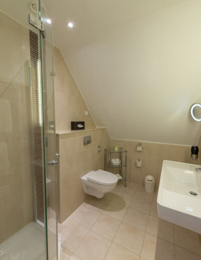 Juniorsuite, Bad mit Dusche und WC, beleuchtete Spiegel über Waschtisch, Handtuchtrockner rechts